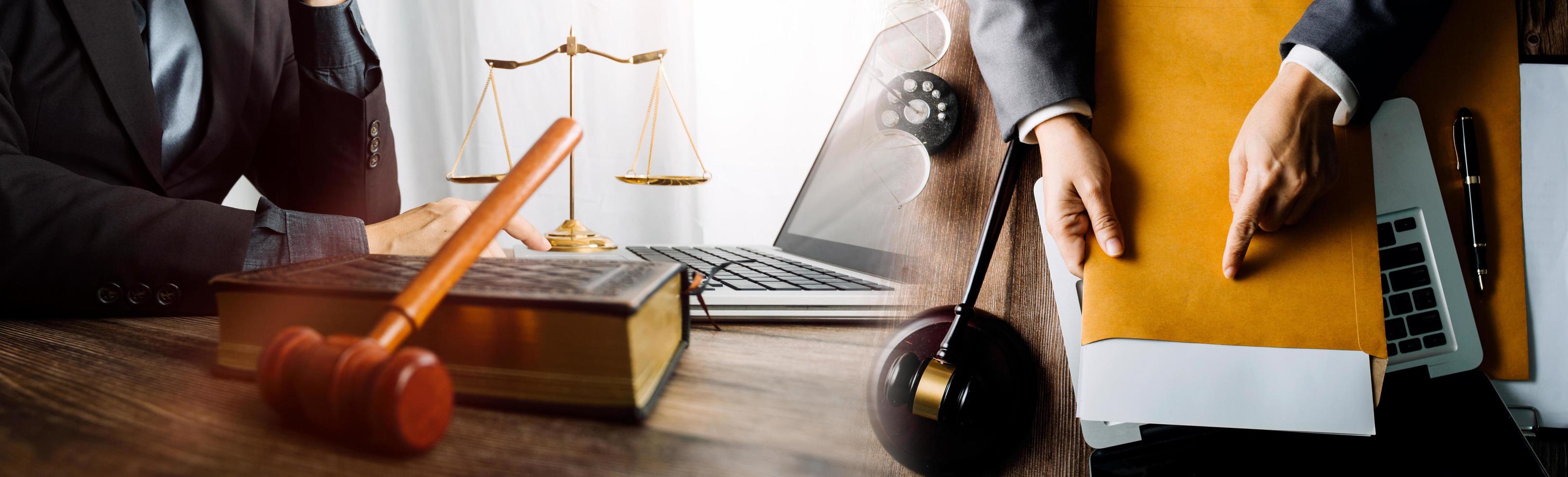 Business and lawyers discussing contract papers with brass scale on desk in office. Law, legal services, advice, justice and law concept picture with film grain effect photo