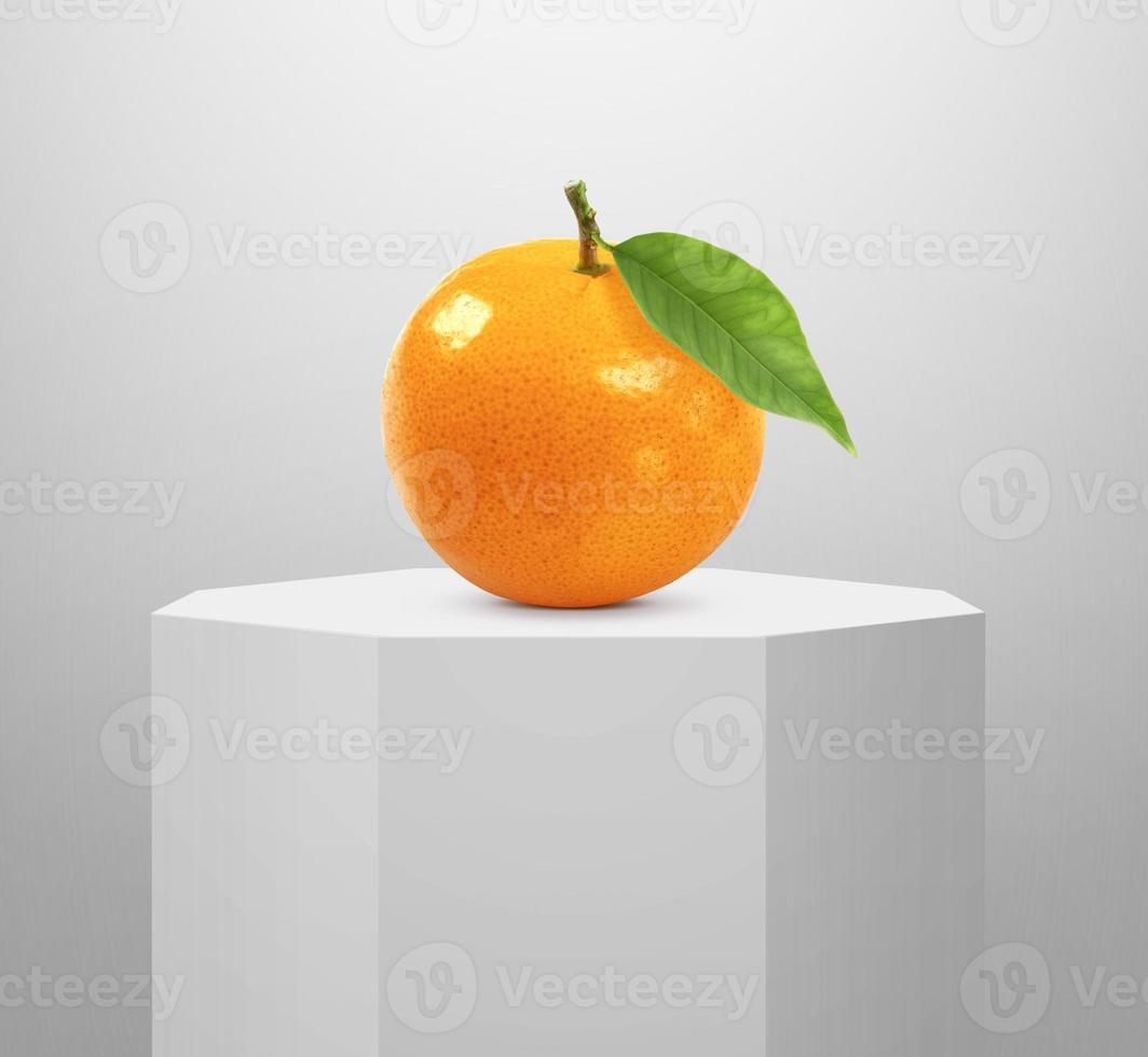 Orange fruit, on Shiny white round pedestal podium photo