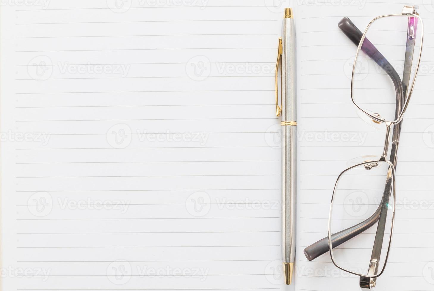 Notebook open blank page and Eyeglasses photo