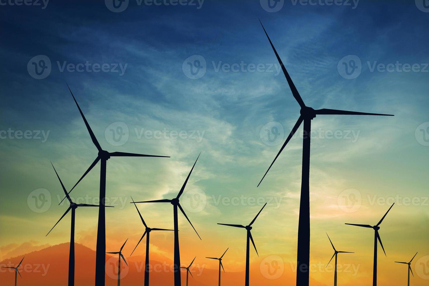concept idea eco power energy. wind turbine on hill with sunset photo