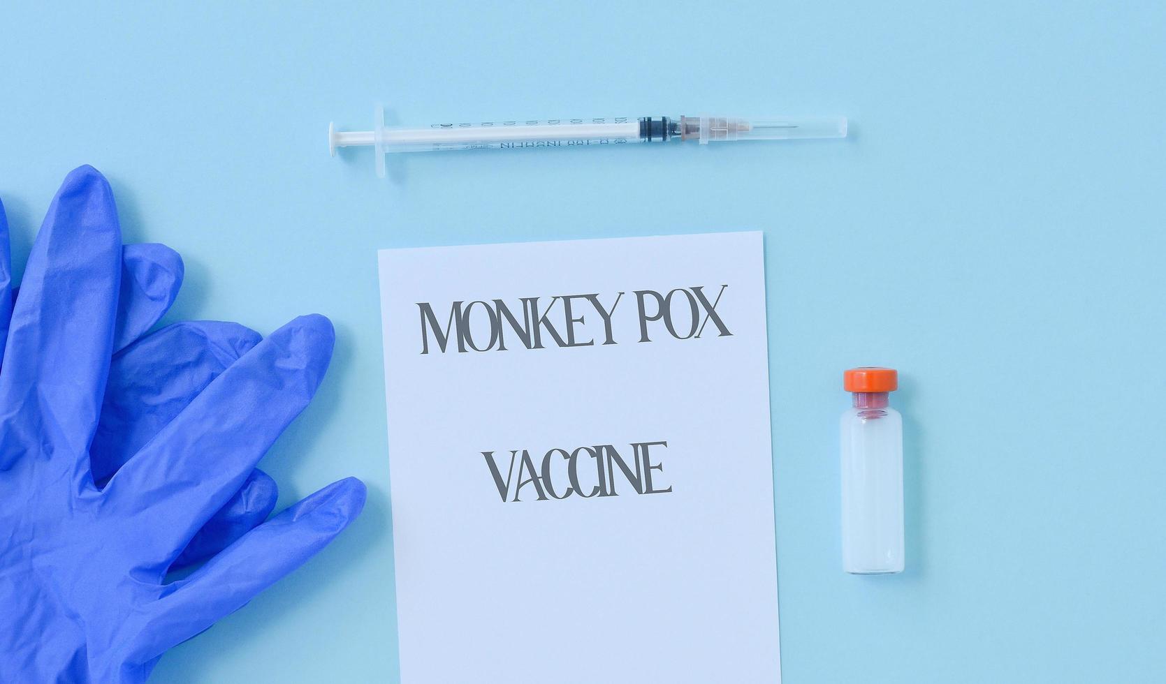 Top view of medical supplies, a syringe, gloves and a test tube with a vaccine against a new virus. photo