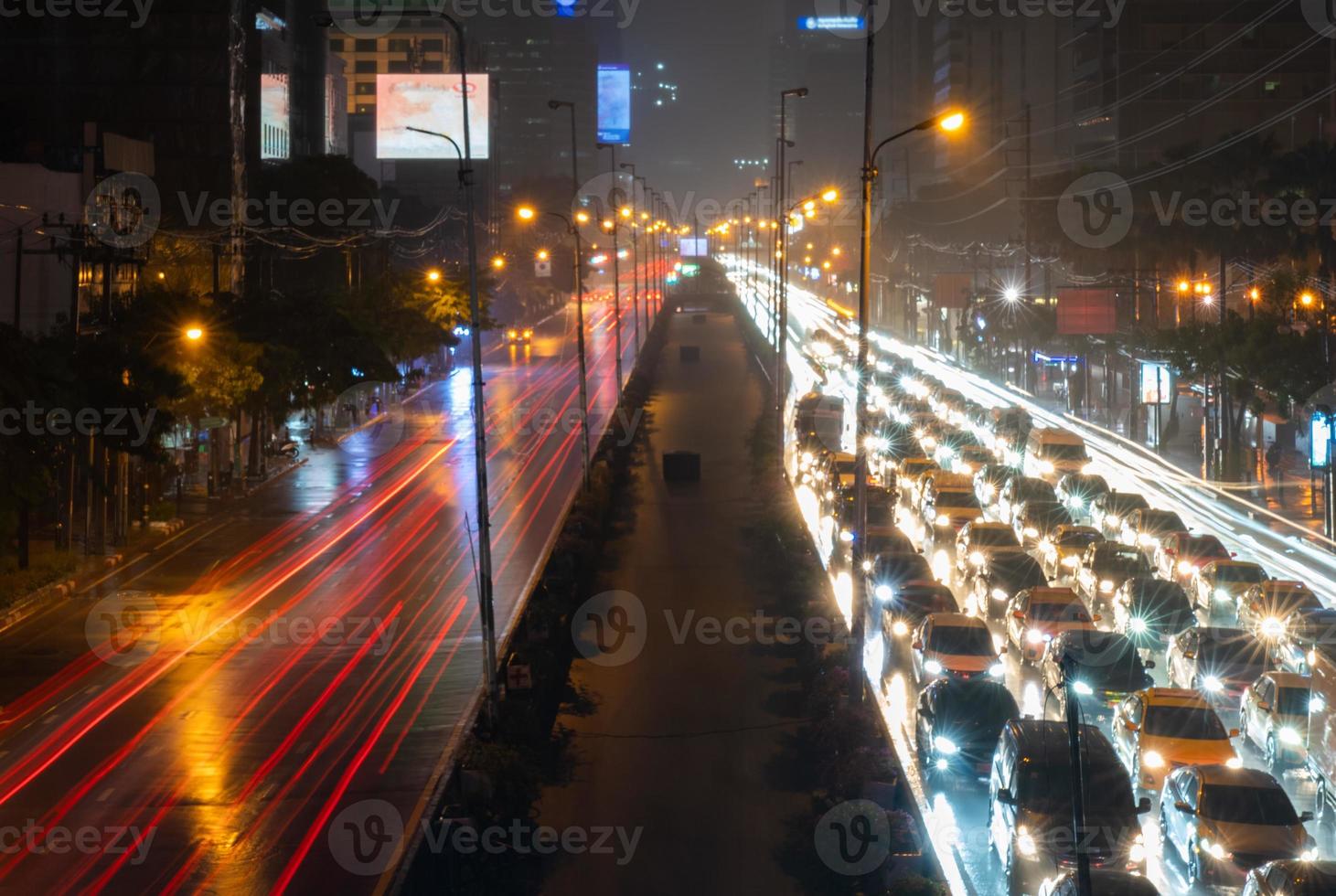 paisaje urbano de bangkok por la noche con atasco de tráfico en días lluviosos foto