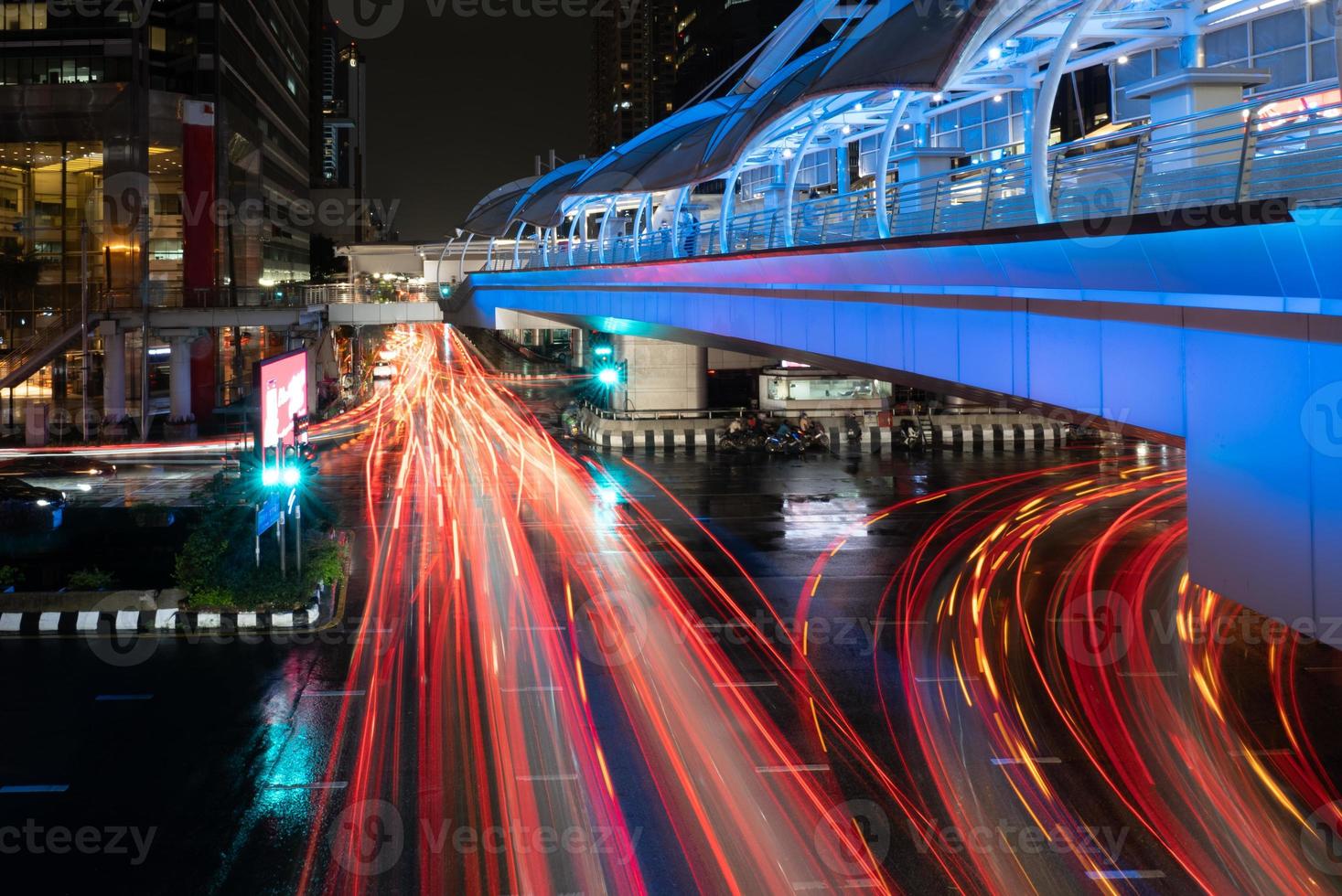 Cityscape of Bangkok at Night with Illumination of Skywalk and Vehicles photo