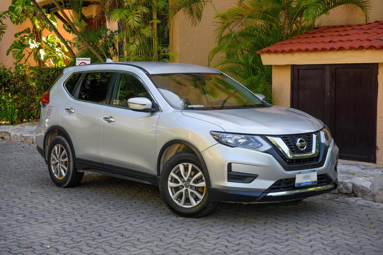 PLAYA DEL CARMEN, MEXICO - APR 2022 silver Nissan X-Trail 3 III near the house photo