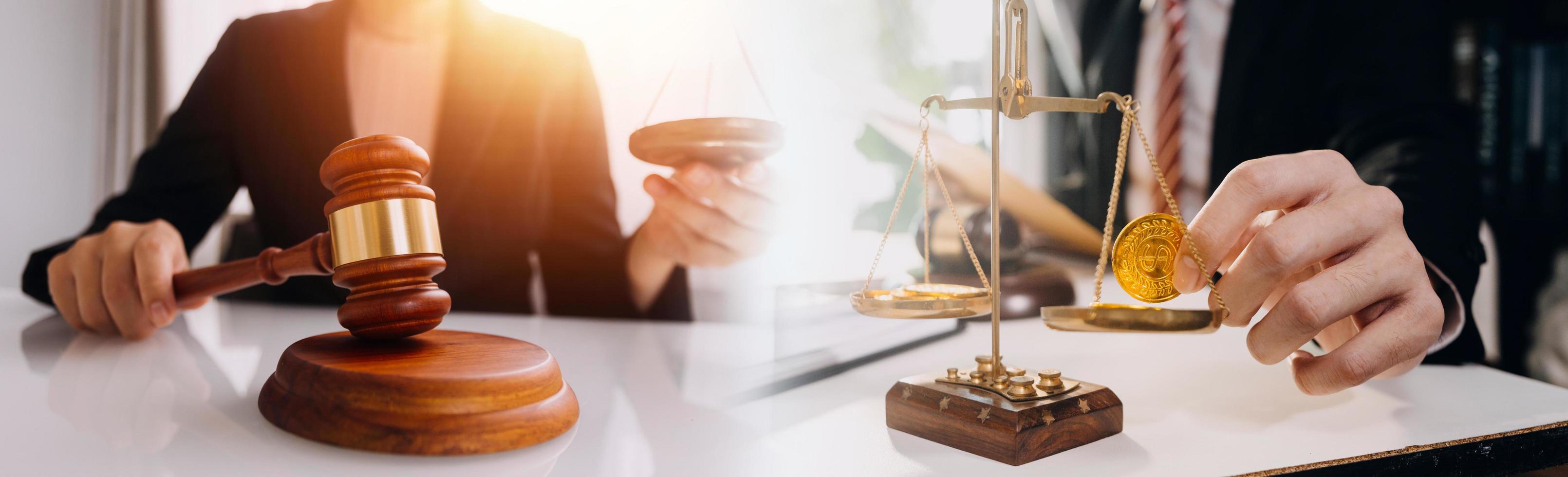 Justice and law concept.Male judge in a courtroom with the gavel, working with, computer and docking keyboard, eyeglasses, on table in morning light photo