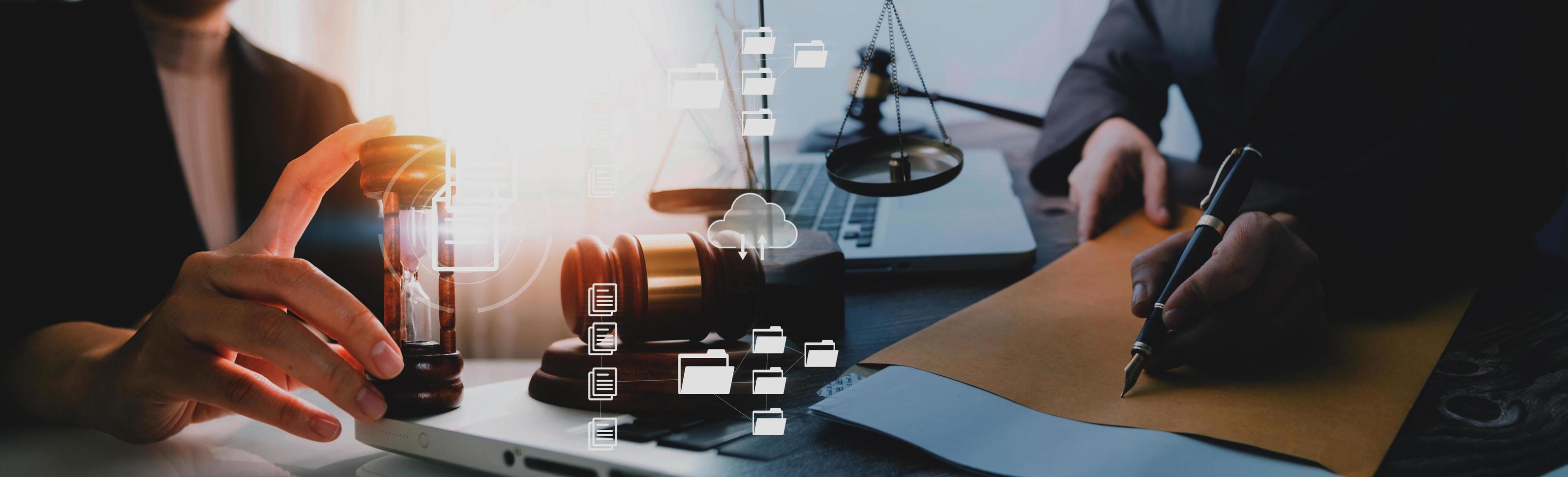 Justice and law concept.Male judge in a courtroom with the gavel, working with, computer and docking keyboard, eyeglasses, on table in morning light photo