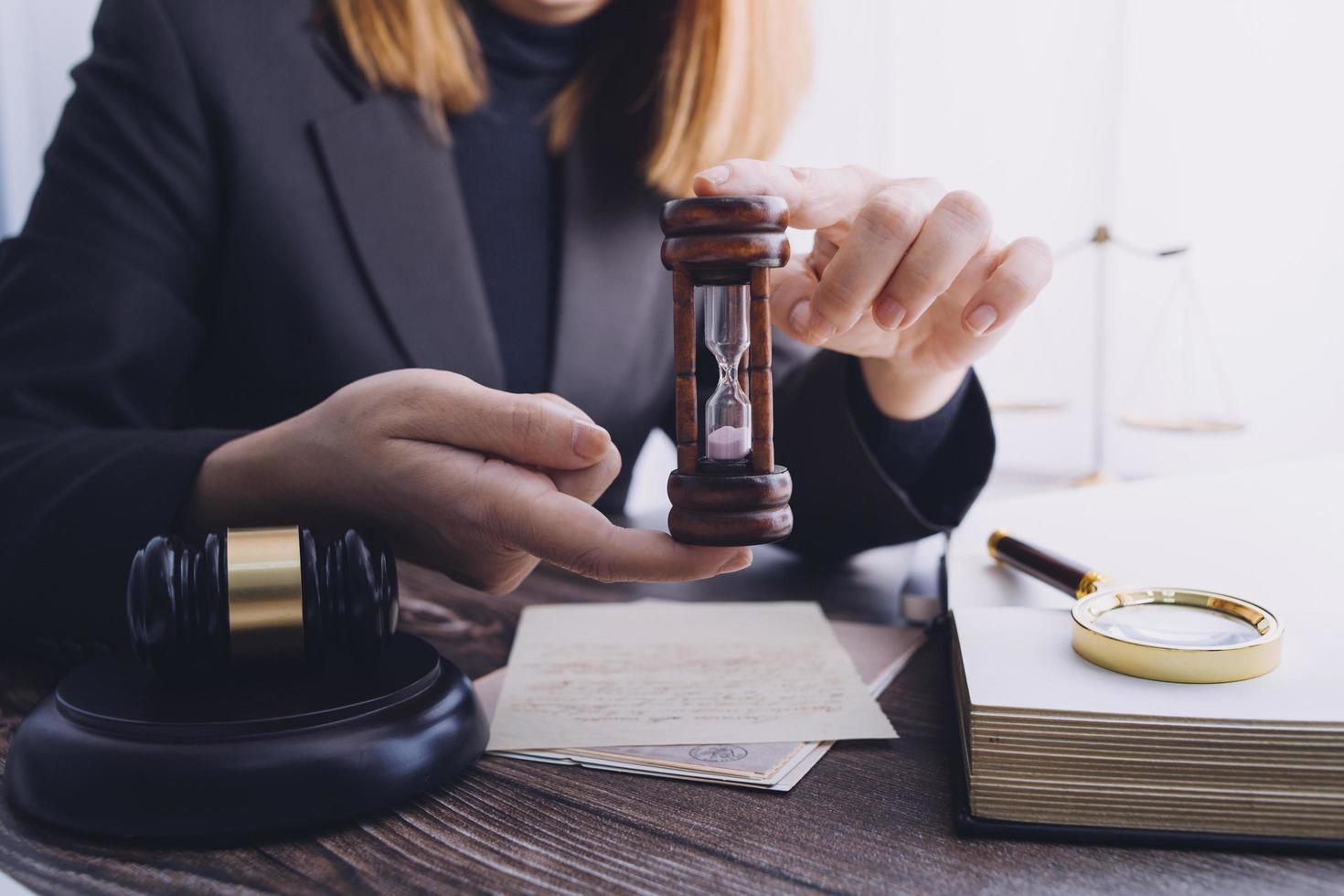 Justice and law concept.Male judge in a courtroom with the gavel, working with, computer and docking keyboard, eyeglasses, on table in morning light photo