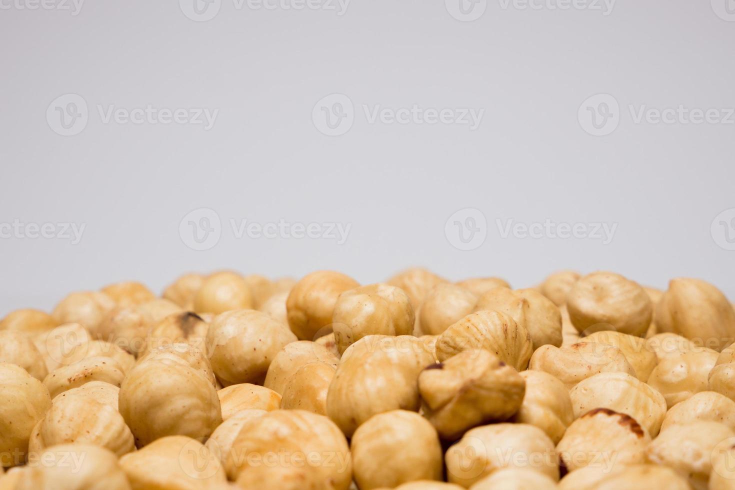 Whole hazelnuts on the white background. Healthy vegetarian snack. Close-up photo. Copy-space for your text. High quality photo
