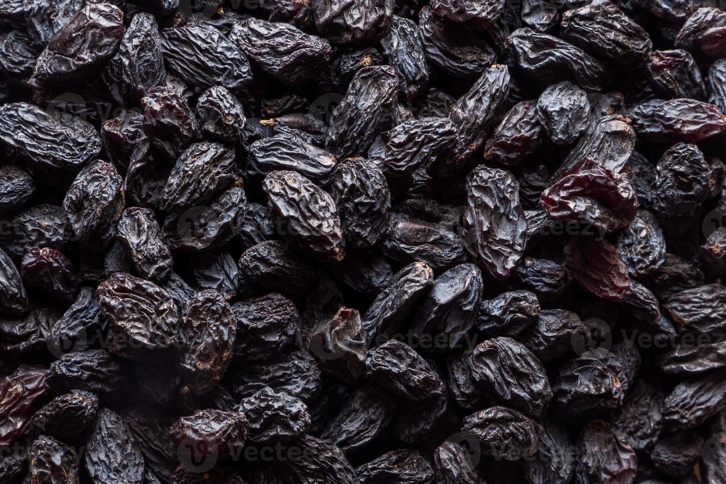 Black raisins background. Vegetarian healthy snack. Organic food. Vegetable diet. High quality photo