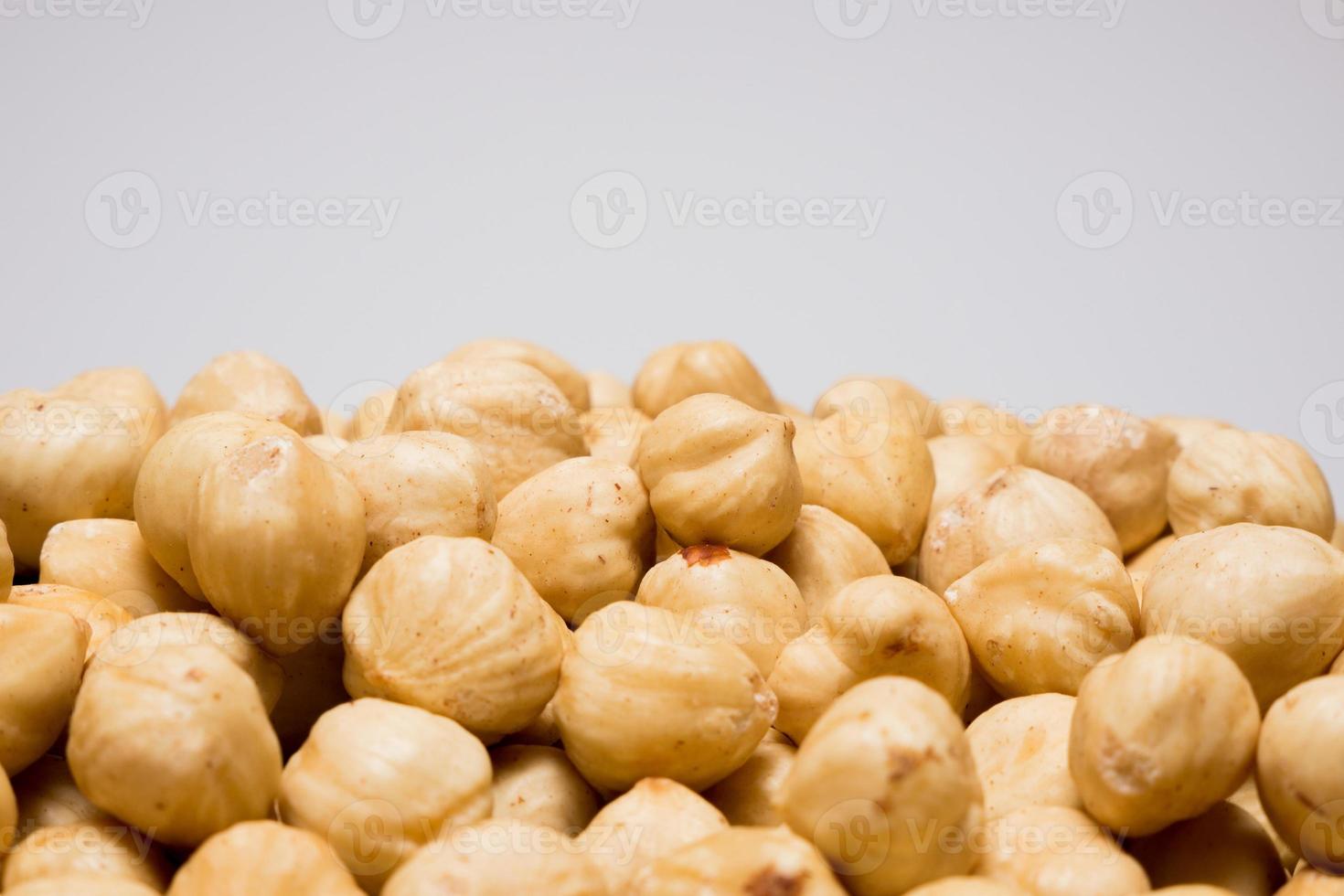 Whole hazelnuts on the white background. Healthy vegetarian snack. Close-up photo. Copy-space for your text. High quality photo