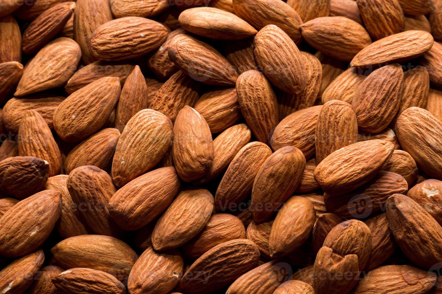 Whole almond nuts background. Vegetarian healthy snack. Organic food. Vegetable diet. High quality photo
