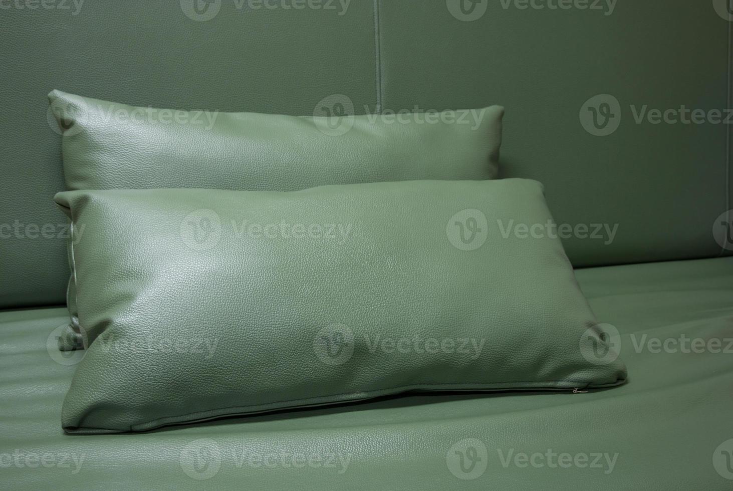 green leather pillow on the sofa photo