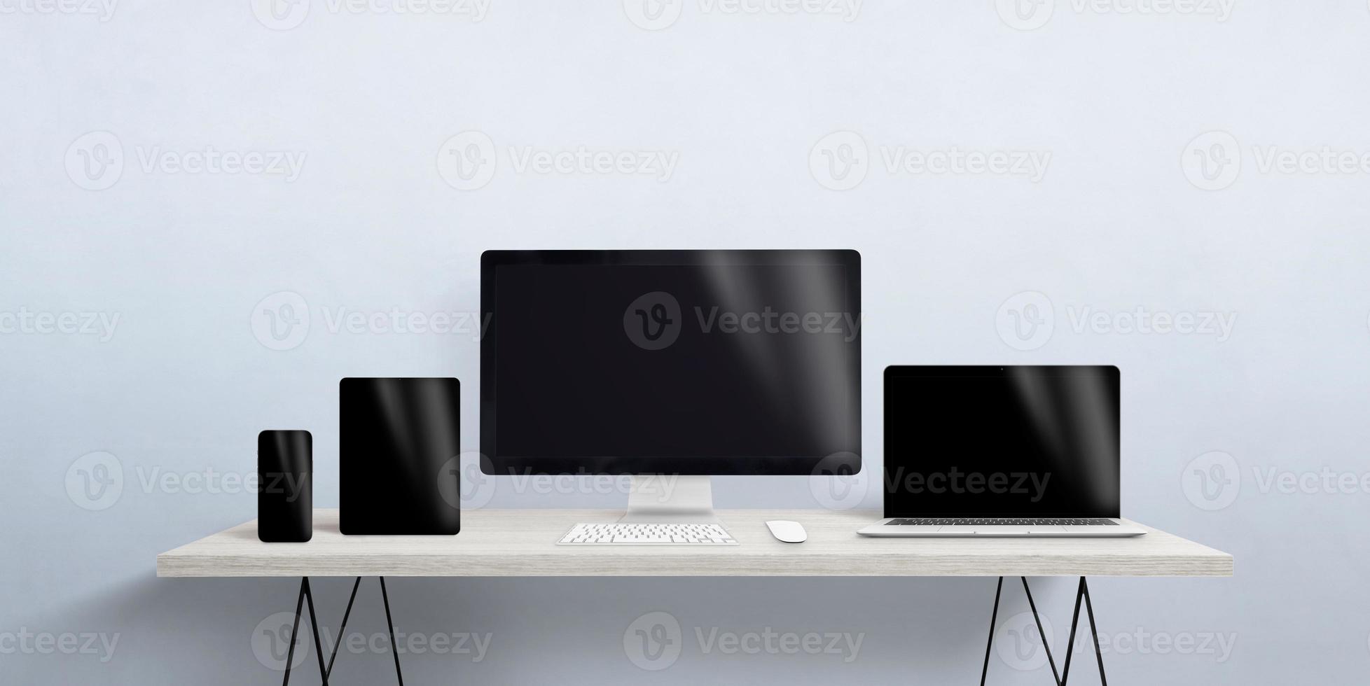 Turned off devices of different sizes on the desktop. Blank screen for responsive web page or app promotion. Computer display, laptop, tablet and smart phone photo