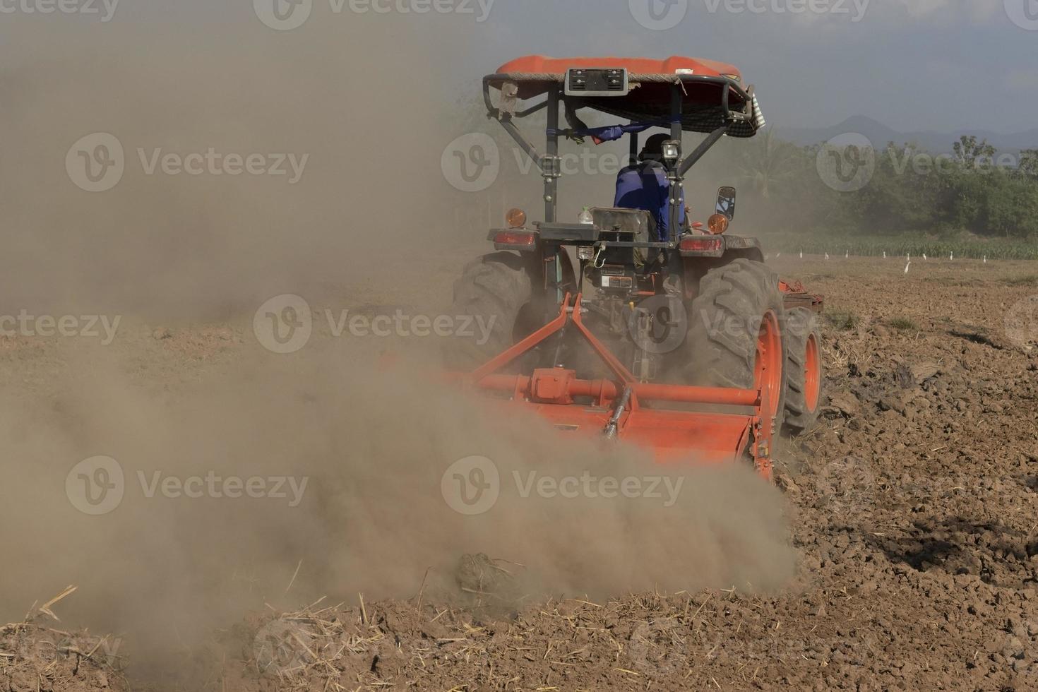 Farmers in tractors prepare land cultivators. tractors plowing the soil to adjust the soil for agriculture photo