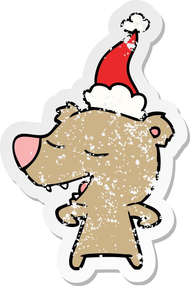 distressed sticker cartoon of a bear wearing santa hat vector