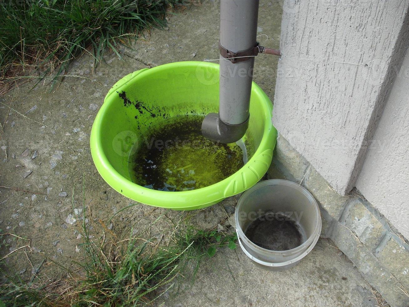 Drinking bowl for animals from rainwater collected from the roof photo