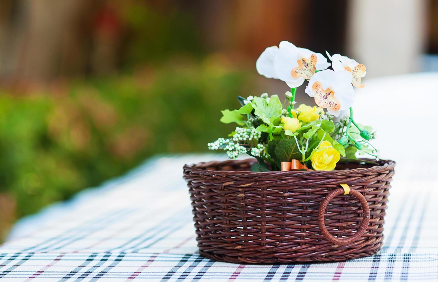 Beautiful flower artificial decoration pot on top of table for greeting card and other background use photo