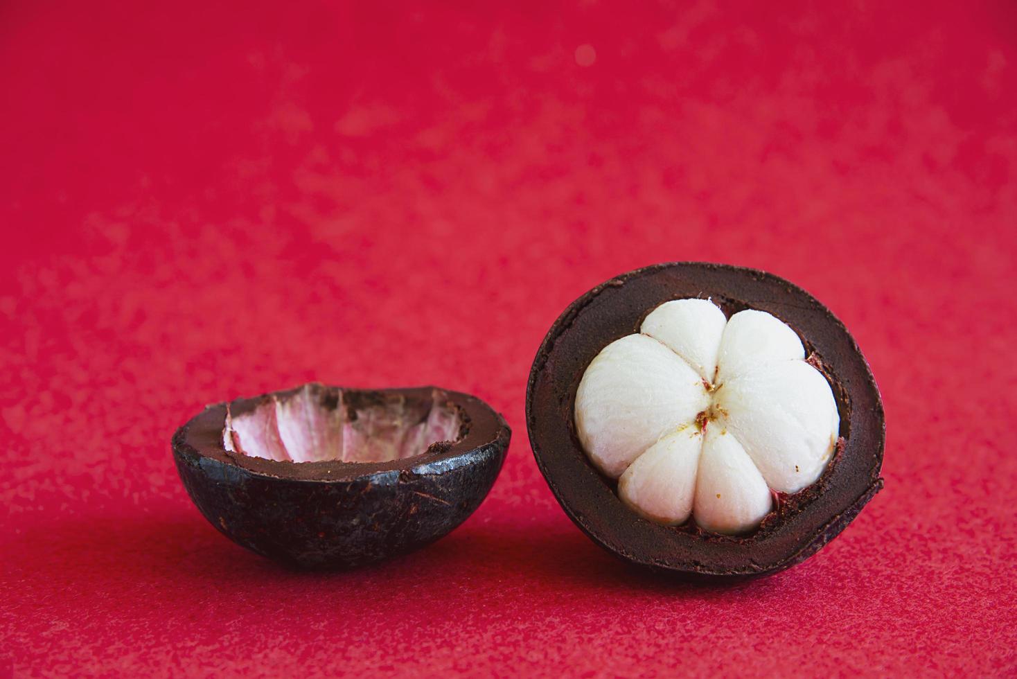 Mangosteen Thai popular fruits - a tropical fruit with sweet juicy white segments of flesh inside a thick reddish-brown rind. photo