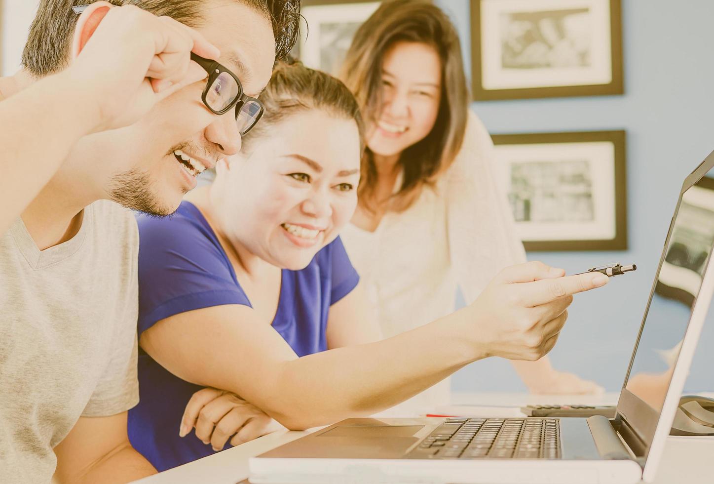 Vintage style photo of two women and one man are working in modern office