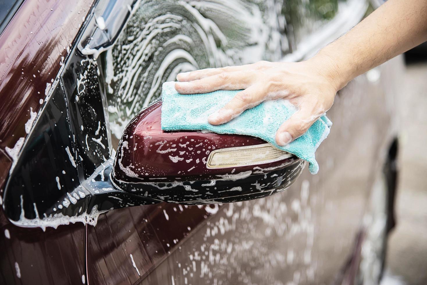 Man wash car using shampoo - every day life car care concept photo