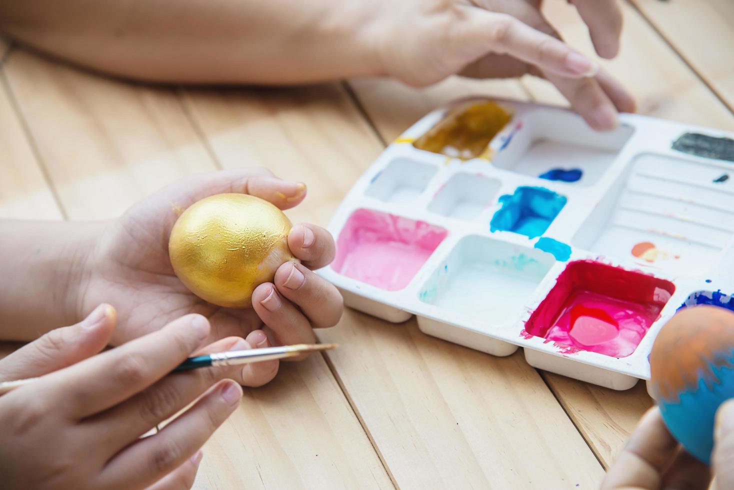 People painting colorful Easter eggs - Easter holiday celebration concept photo