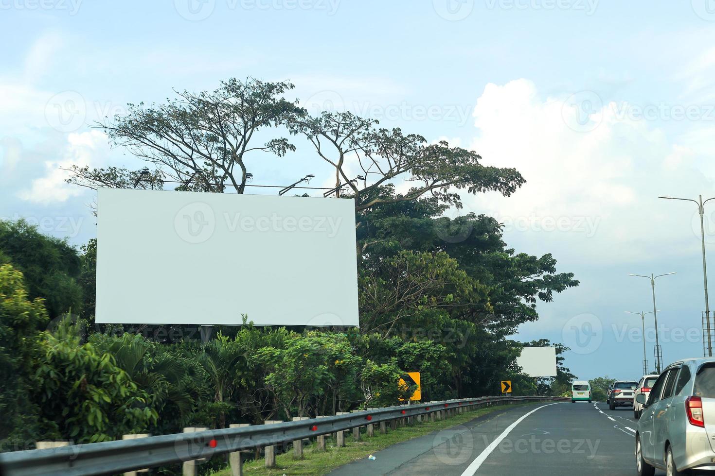 Billboard mockup in highway with traffic atmosphere under beautiful sky. photo