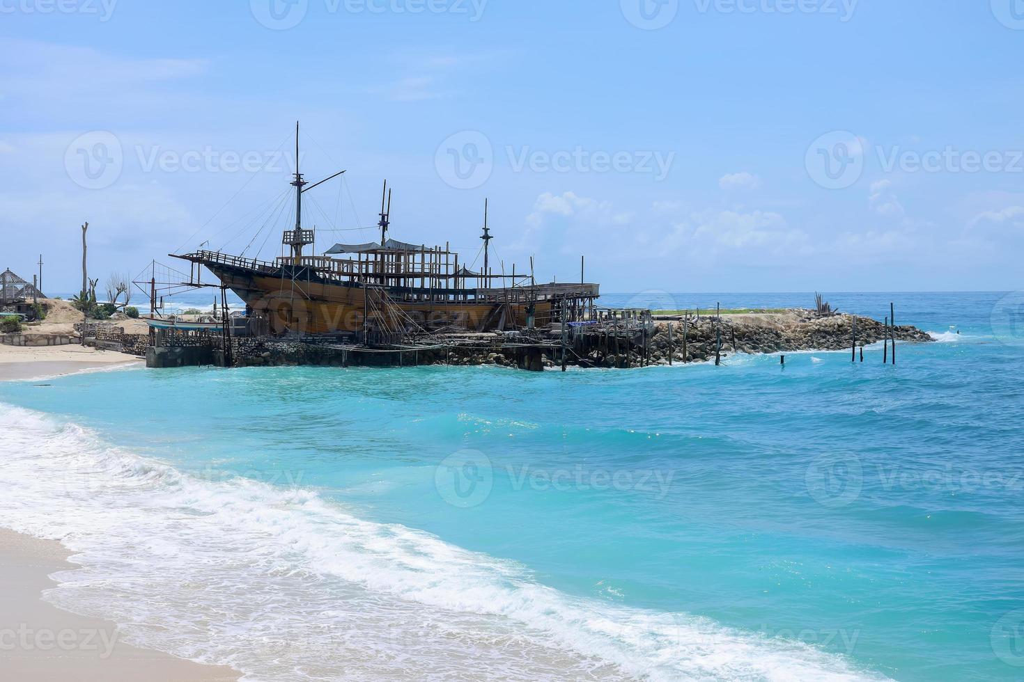 Wooden sailing ship constructed in marine workshop on the beautiful sunny day, a place for maintenance and parking. photo