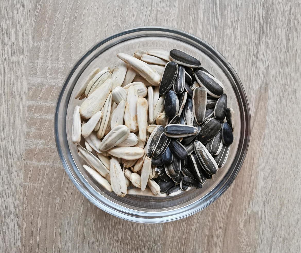 Salted sunflower seeds in black and white colors photo