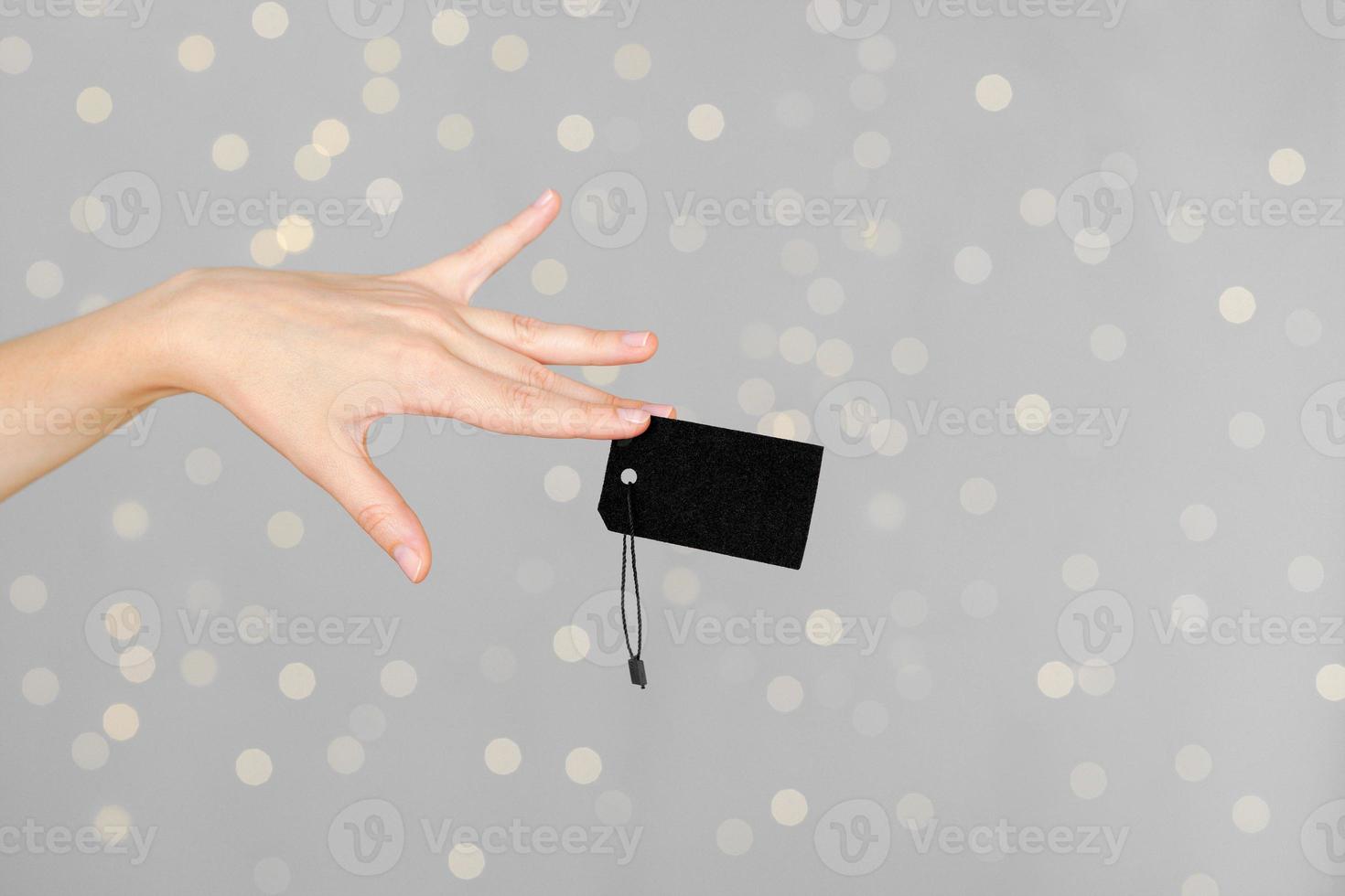 Woman hand with price tag photo