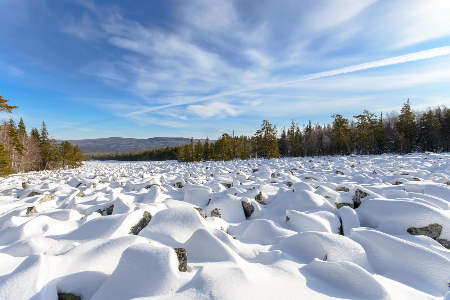 Sea of stones covered with snow, beautiful winter landscape. On the way to the mountains. photo