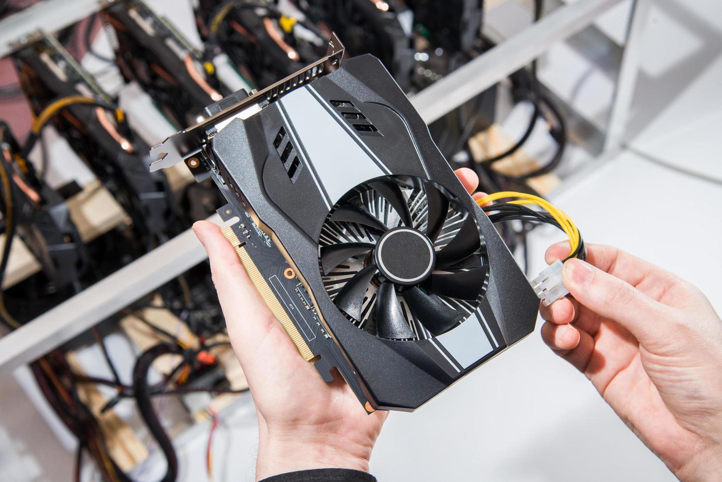 Graphics cards standing in a row in home mining farm. Close-up shot. Cryptocurrency industry. photo