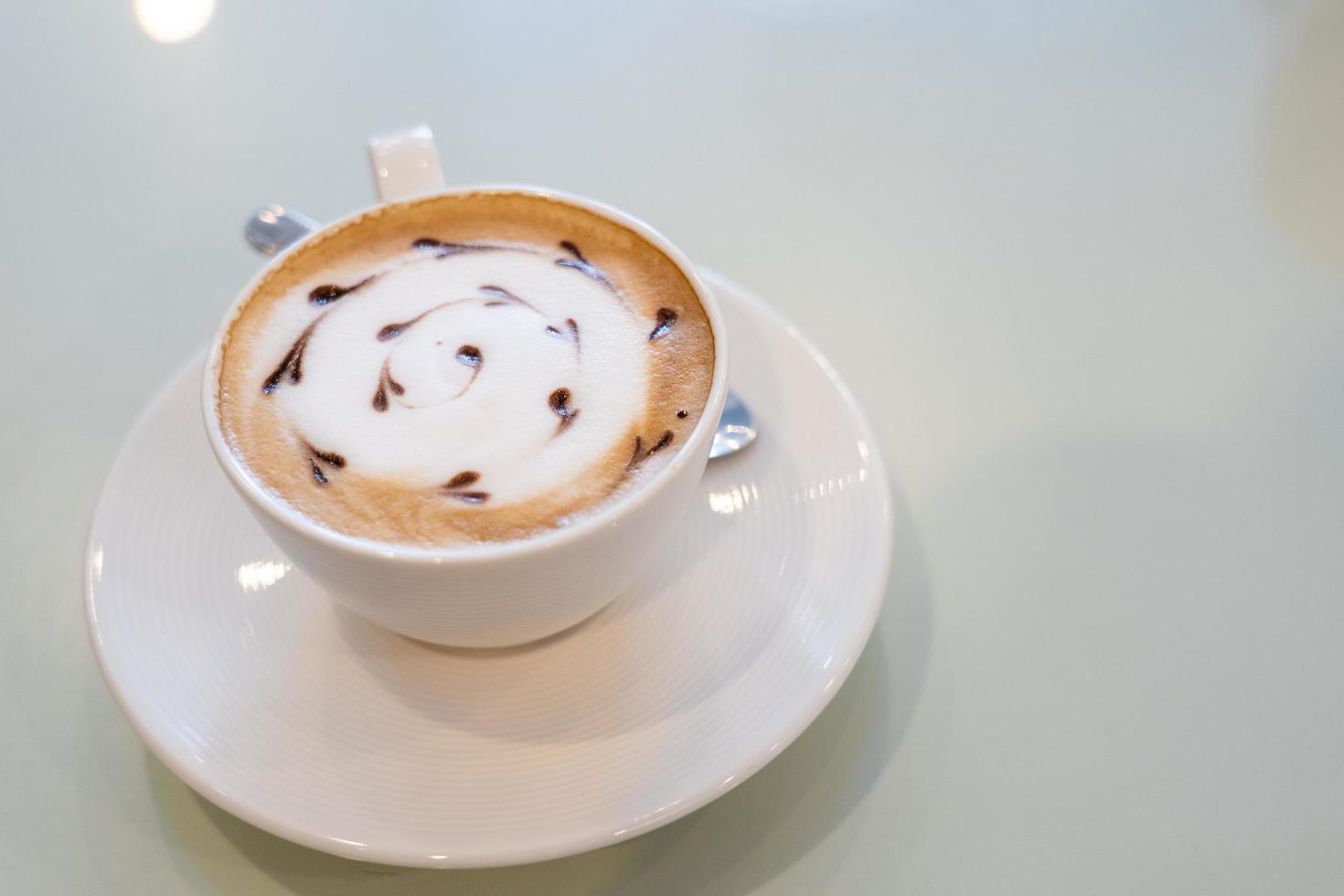 View of Coffe latte art on whtie o photo