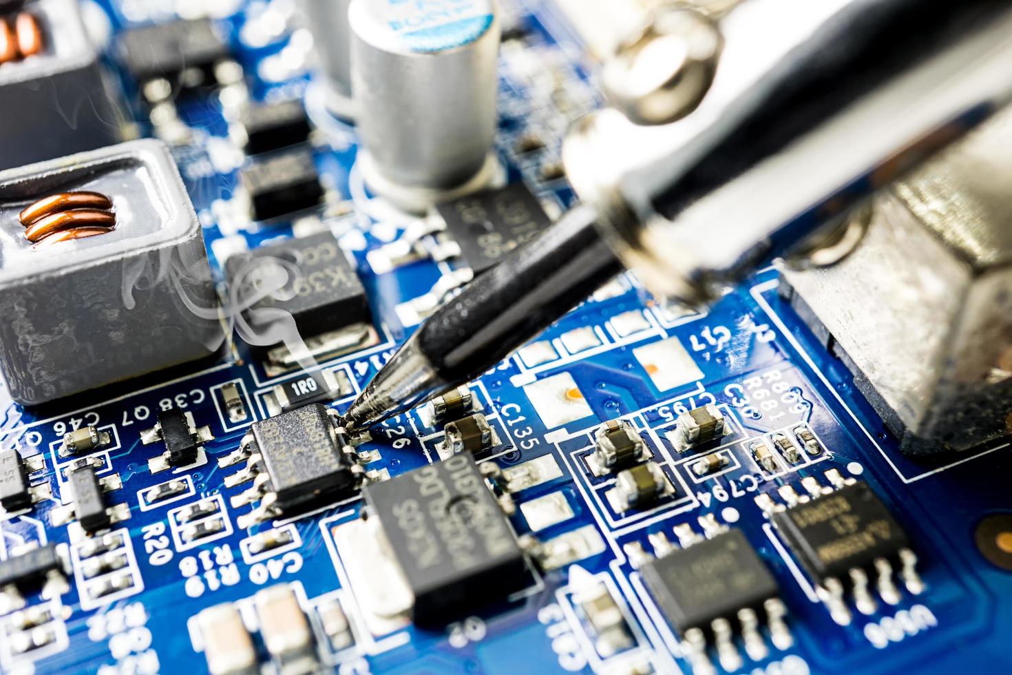 Fixing microchip with soldering iron photo
