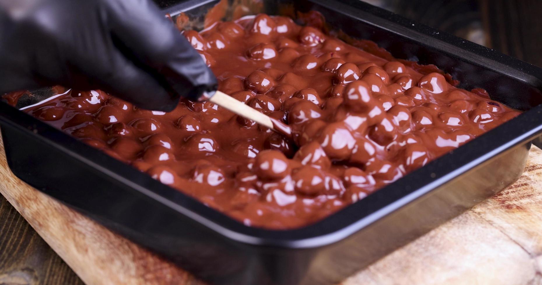 mixing hot chocolate during its preparation with hazelnuts photo