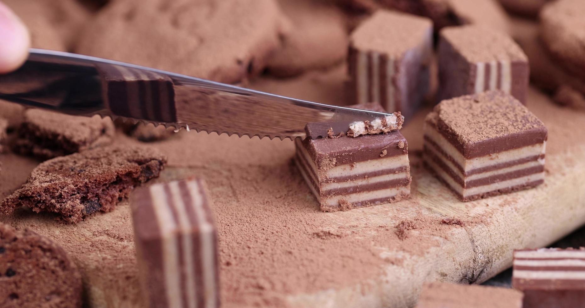 cutting candy on a board with a knife photo