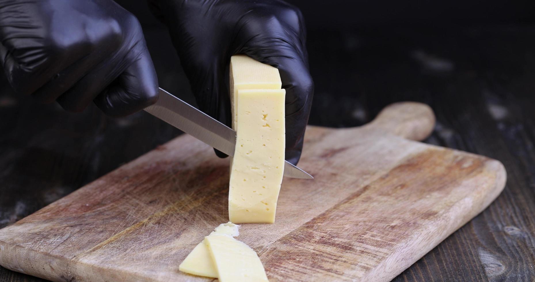 cut into pieces real hard cheese with lots of milk photo