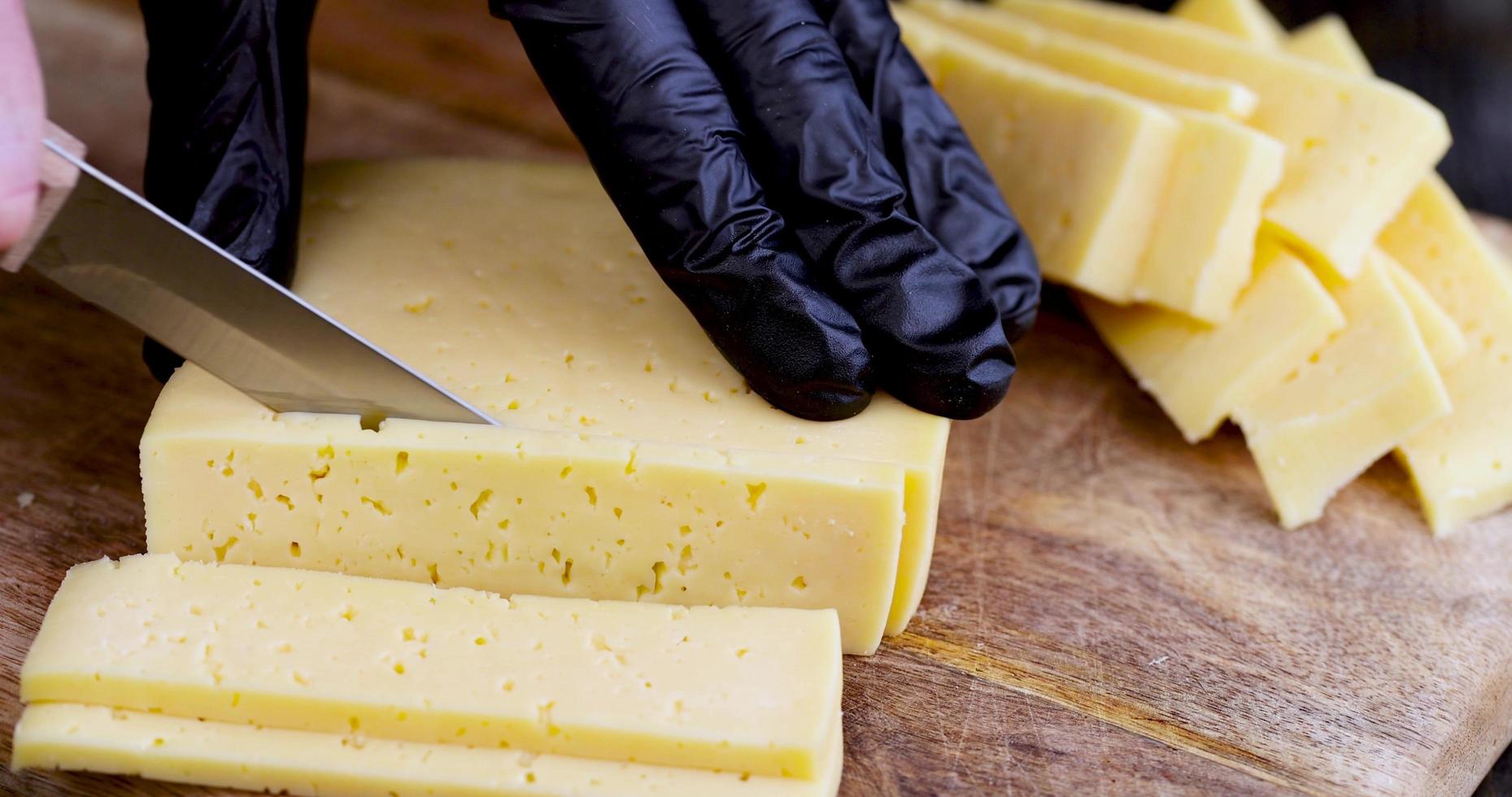 slicing ripe delicious cow's milk cheese photo