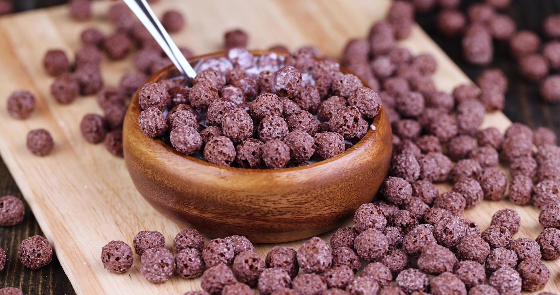 take chocolate balls in milk with a spoon photo
