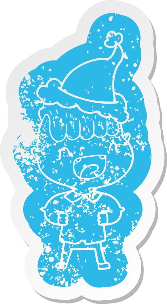 cartoon distressed sticker of a happy boy laughing wearing santa hat vector