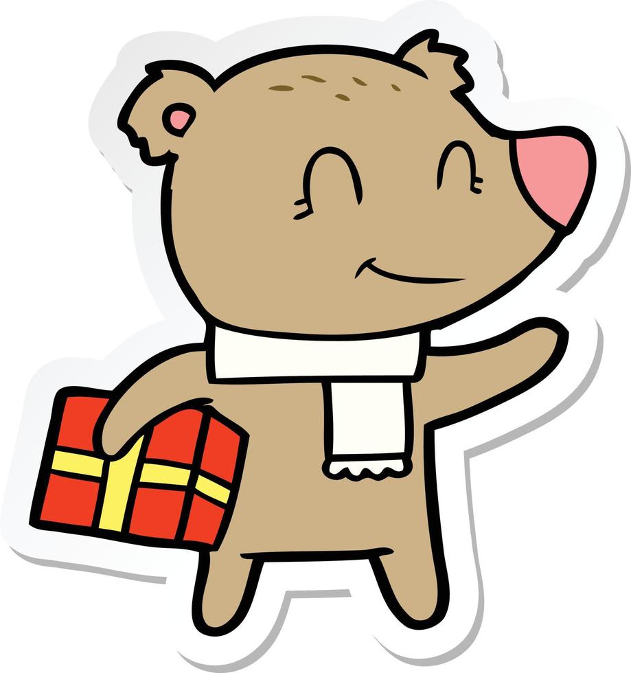sticker of a friendly bear with xmas gift and scarf vector