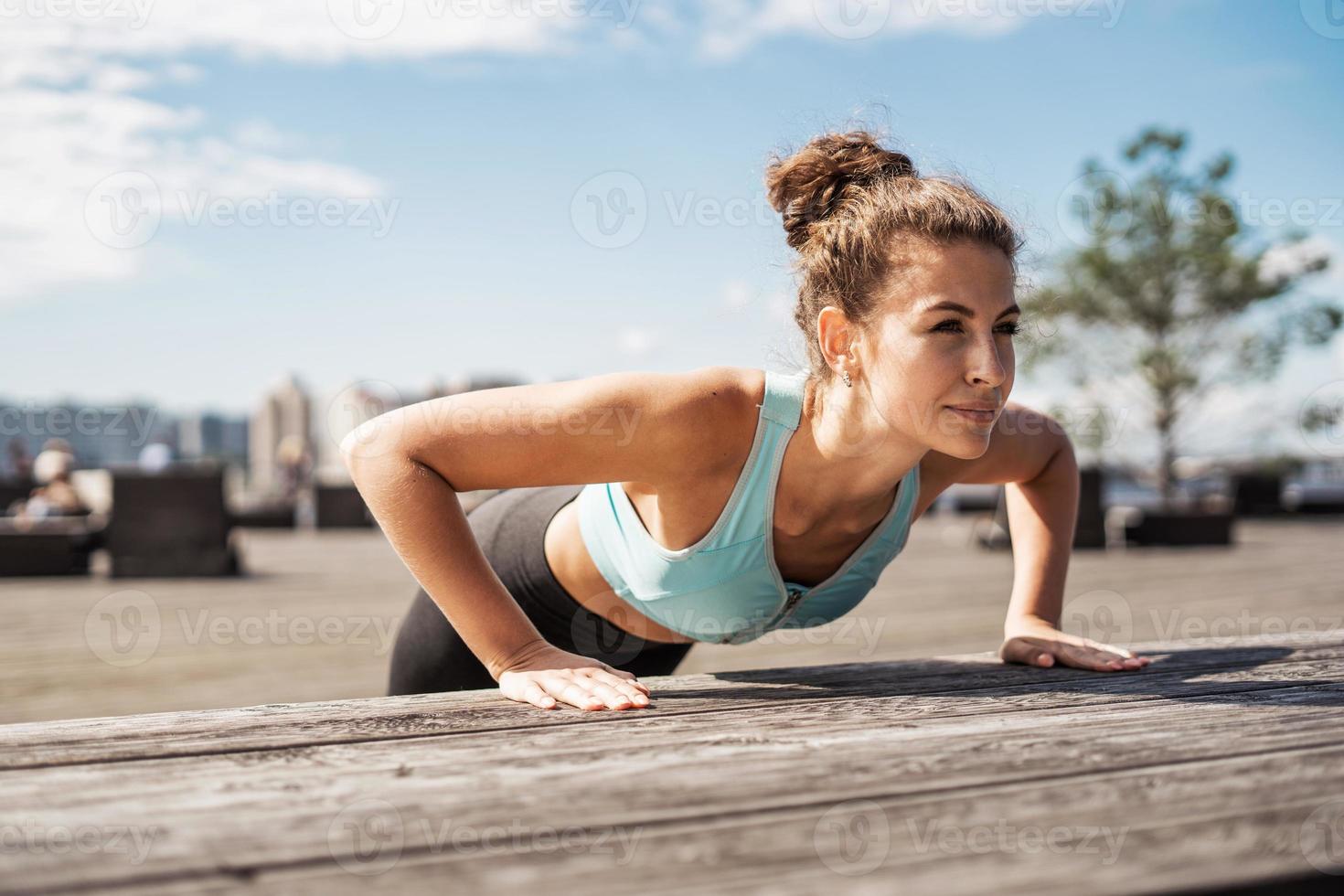 Doing exercises sports fitness young woman photo