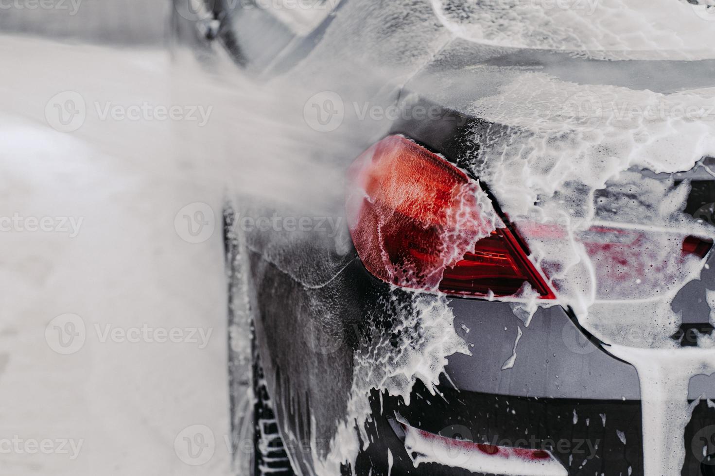 Car washing concept. Auto cleaning with high pressure of water. Contactless self service car wash. Close up shot. Selective focus. photo