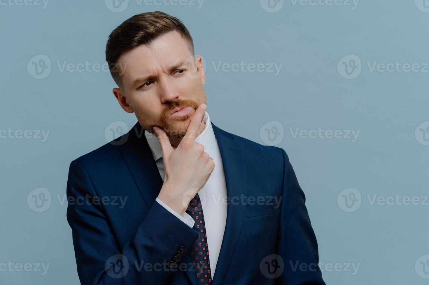 Frustrated businessman thinking about something and looking away photo