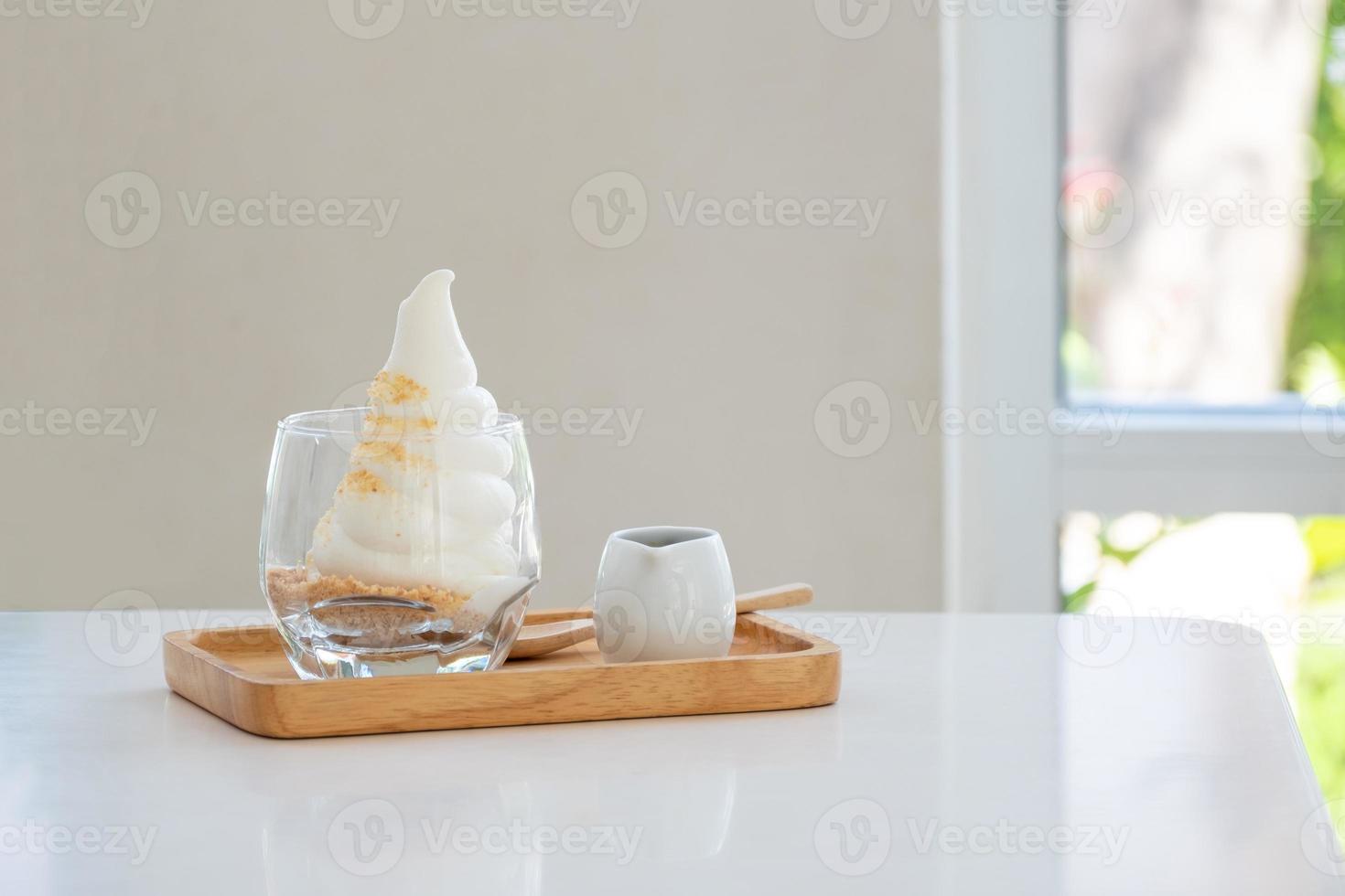 Affogato Espresso on wooden disk on the white table near windows in coffee shop, ice cream, cafe, copy space photo