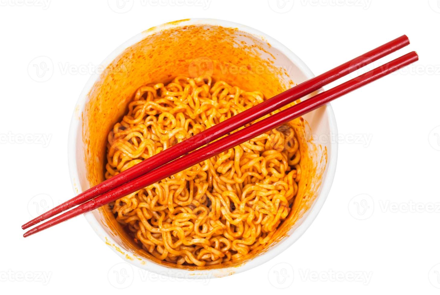 red chopsticks over cup with spicy instant noodles photo