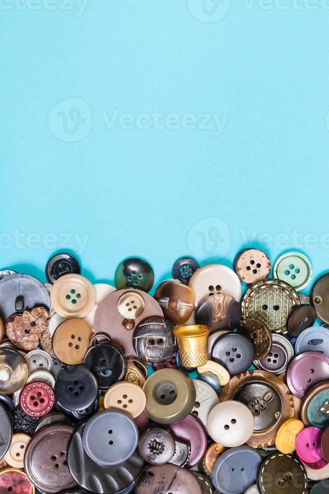 pile of various buttons on blue with copyspace photo