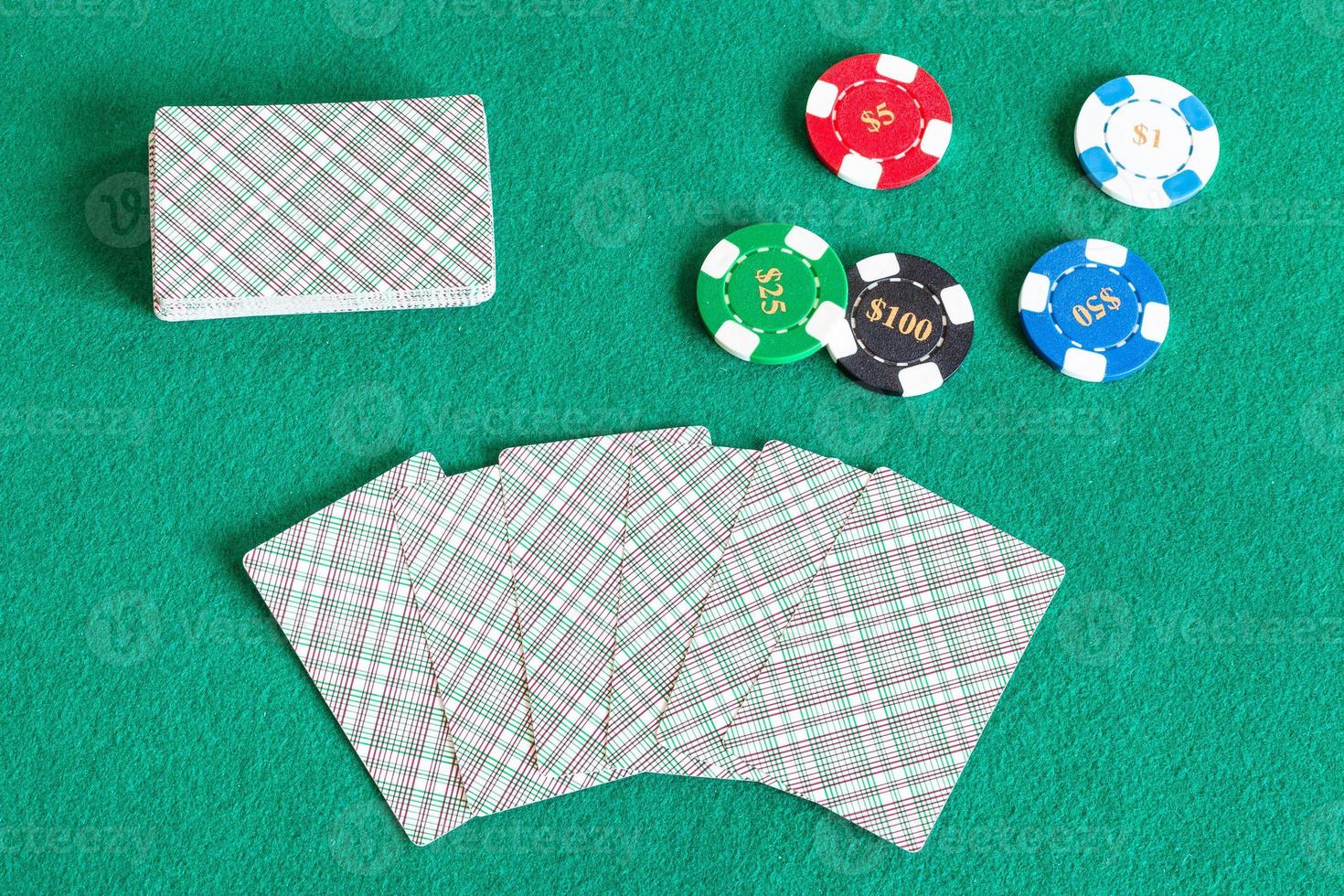 card decks and casino tokens on green table photo