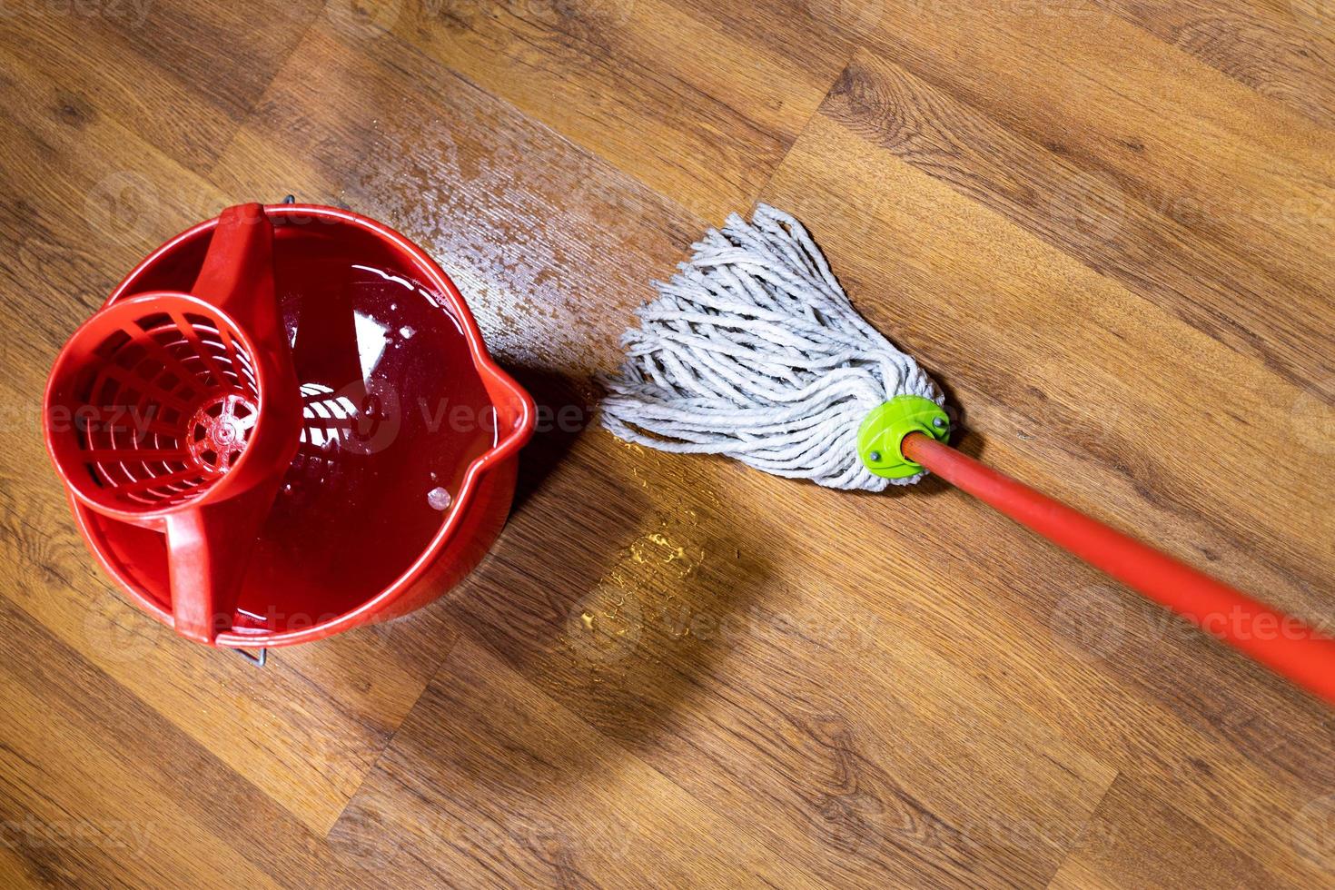 top view of rope mop cleans wooden laminate floor photo