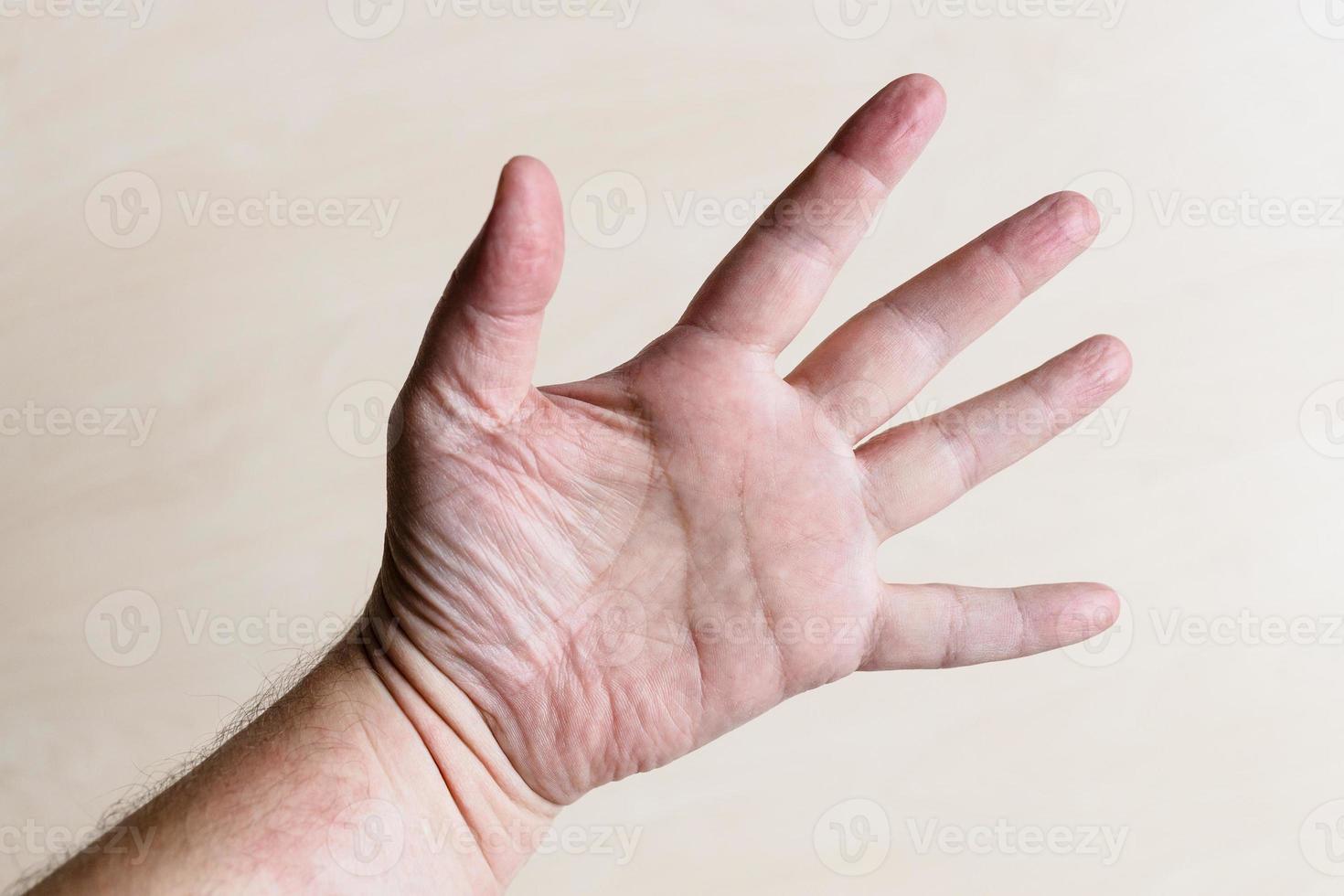 male palm with spread out five fingers close up photo