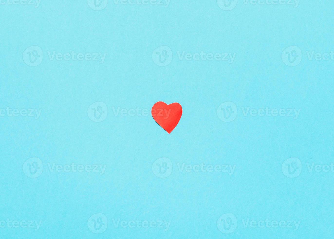 red paper cut heart on blue turquoise paper photo